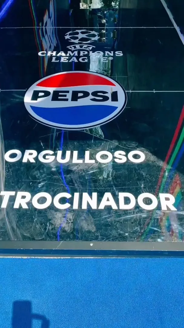 Pepsi "Proud Sponsor" branding with the UEFA Champions League logo on a glass panel